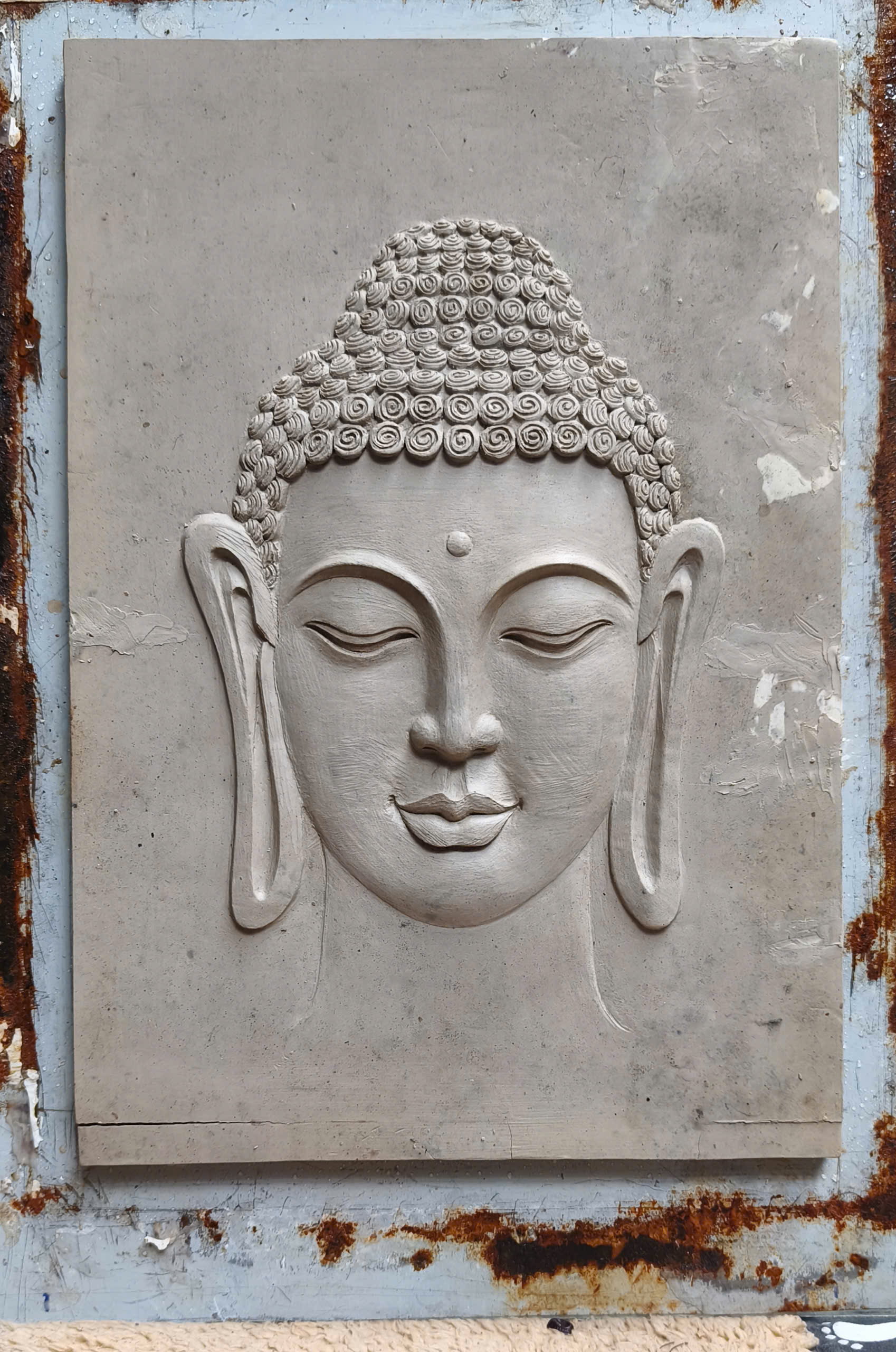 A Buddha wall relief in raw cement, before finishing